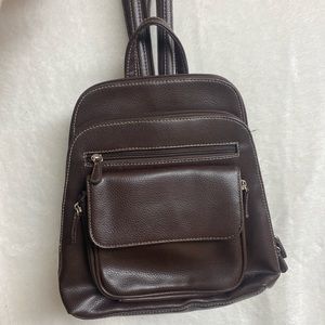 Unisex smaller sized dark brown faux leather backpack.